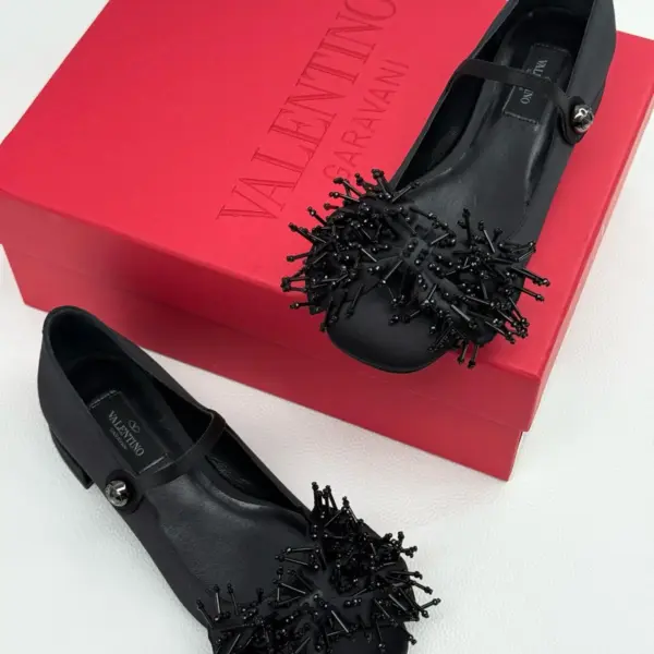 Black Mary Jane flats with beaded toe, three-quarter view