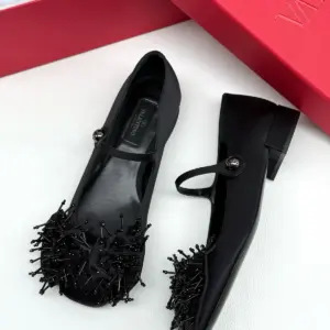 Black Mary Jane flats, pair on a white surface